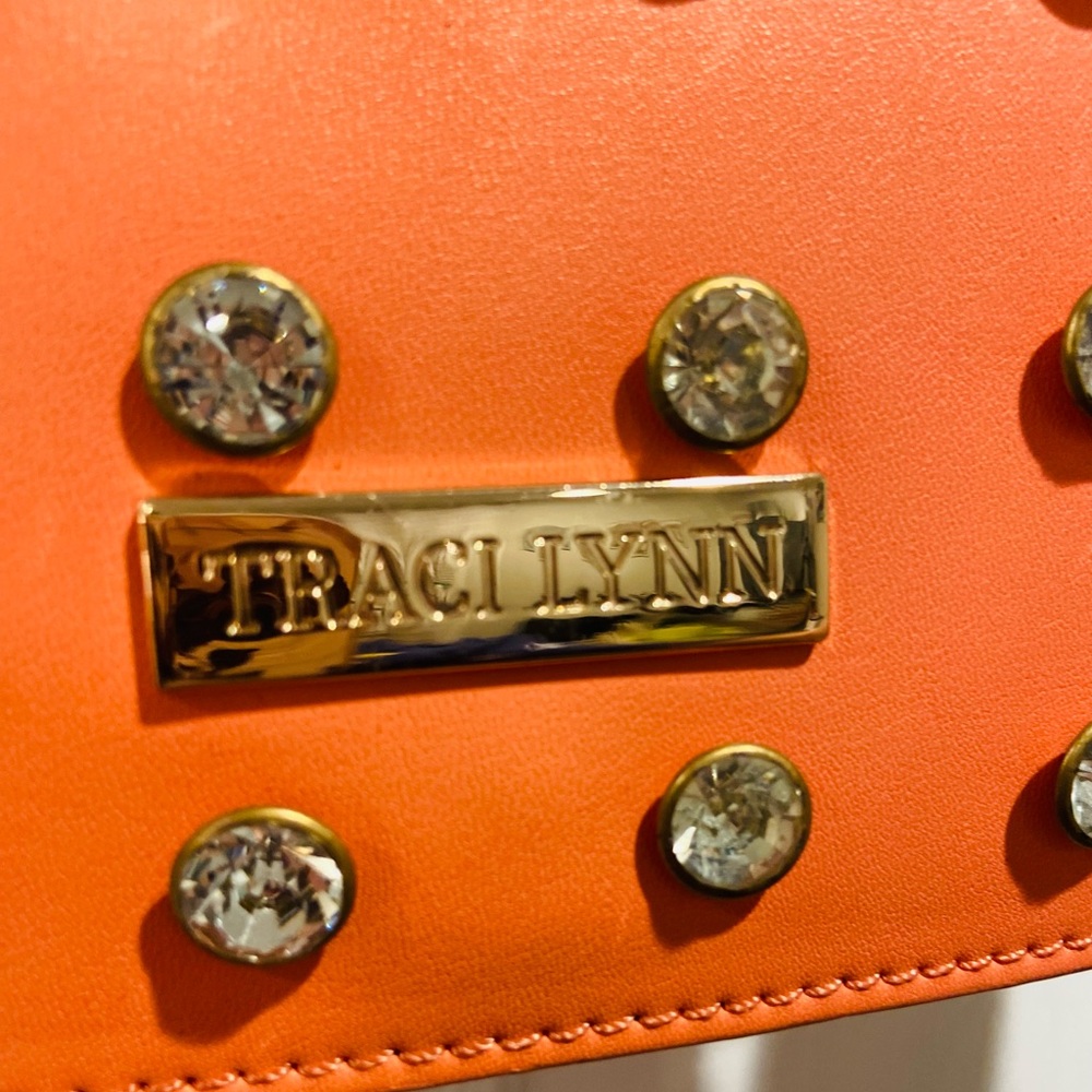 Traci Lynn Orange Studded Wristlet Clutch with Gold Nameplate
